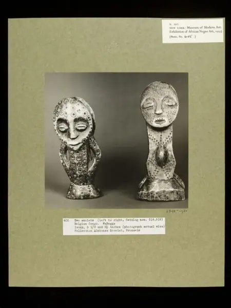 Amulet, Figure with Two Masks / Amulet, Two Figures Embracing. WaRegga.