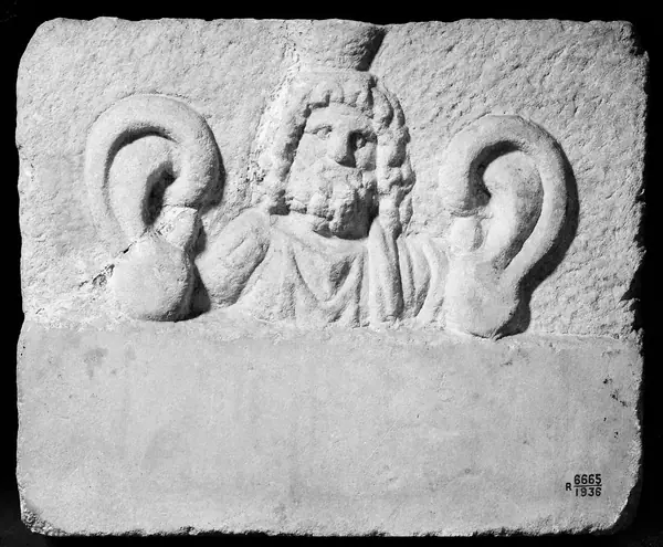 M0015212: Marble votive plaque with relief bust, possibly Serapis, a Greco-Egyptian deity, 1st-3rd century A.D.