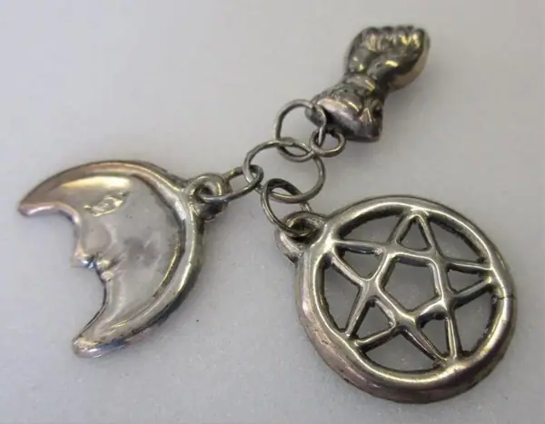 Three silver amulets, shaped like a star, a fist and a crescent moon, Madeira (Portugal), 1890-1910