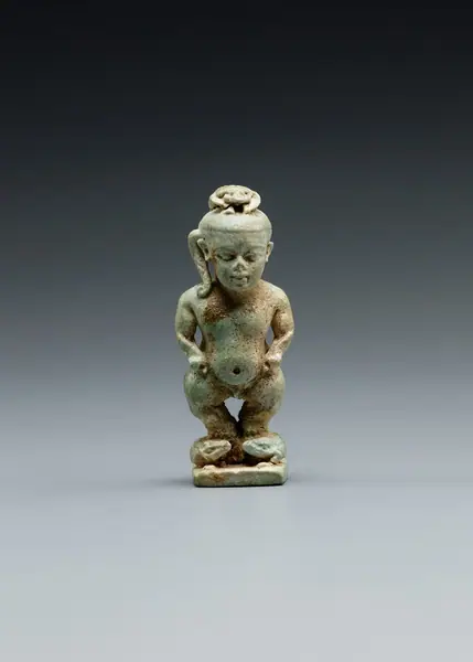 Amulet: Pataikos astride crocodiles and with a scarab on his head
