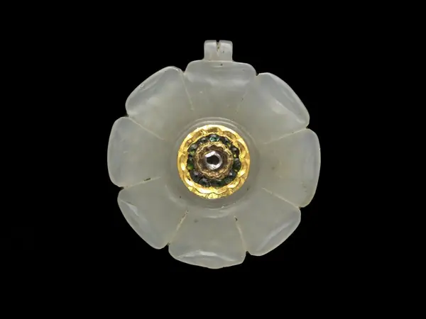 An amulet, carved as a rose, white nephrite jade, inset diamond and other stones in gold or gilt metal, Mughal