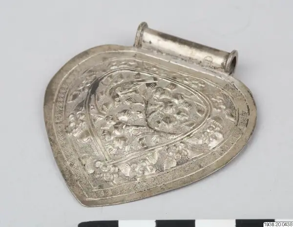 Hängsmycke av låghaltigt silver - Etnografiska Museet