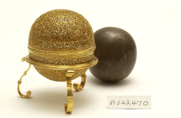 An artificially manufactured version of a goa stone found inside the stomachs of an animal (bezoar stones) and its case. Made in India from a paste of clay, crushed shell, amber, musk and resin and us