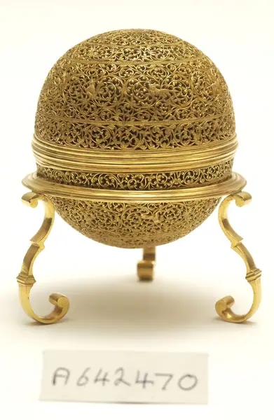 An artificially manufactured version of a goa stone found inside the stomachs of an animal (bezoar stones) and its case. Made in India from a paste of clay, crushed shell, amber, musk and resin and us