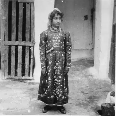A Jewish girl standing in the yard with an amulet over her shoulder