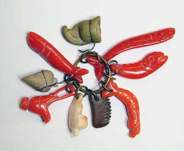 Bunch of nine coral and 'lava' amulets on a silver ring, Malta, 1865-1870
