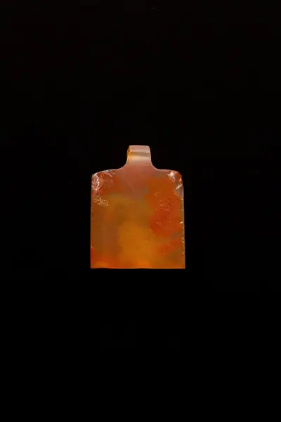 10 Amulets of Henettawy (C): 1 wedjat, 1 scarab, 3 djed pillars, 1 incised plaque, 1 uraeus, 2 wadj signs, and 1 cylindrical bead