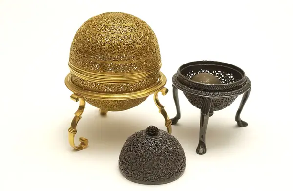 An artificially manufactured version of a goa stone found inside the stomachs of an animal (bezoar stones) and its case. Made in India from a paste of clay, crushed shell, amber, musk and resin and us