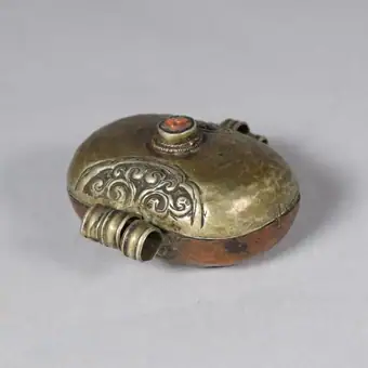 Ga'u made of hammered copper and silver, inset with carnelian, containing image of Padma Sambhava, E.Tibet, 19