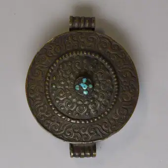 Ga'u made of hammered copper with chased and repoussé decoration and turquoise inlay, E.Tibet, 19th century