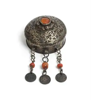 Circular silver box set with a paste cornelian with three silver and coral pendants, Morocco, 1880-1900