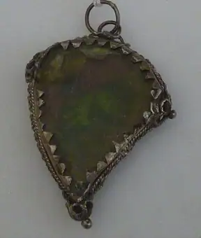 Silver heart-shaped reliquary case containing pieces of brocade, Italy, 1600-1799