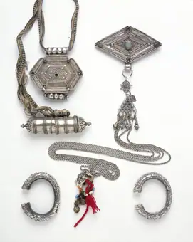 A cylindrical silver amulet box or ga'u chugsung, in two halves containing a roll of printed prayers in Tibeta