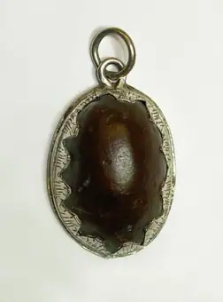 Heart-shaped ironstone (?) amulet mounted in silver, England, 1600-1699