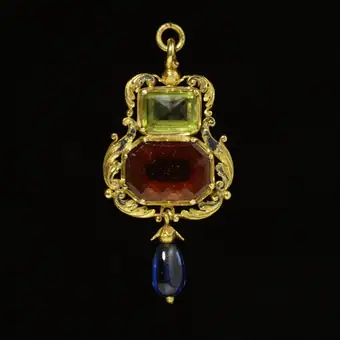 Prophylactic pendant, gold, enamelled and set with a hessonite garnet and a peridot, and hung with a sapphire,