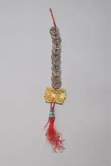Wedding charm, coins threaded on red silk cord with tassel, Hong Kong, 1950-1990
