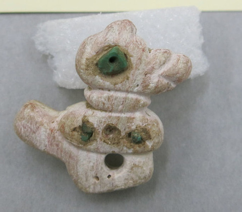 An amulet in the shape of a bird